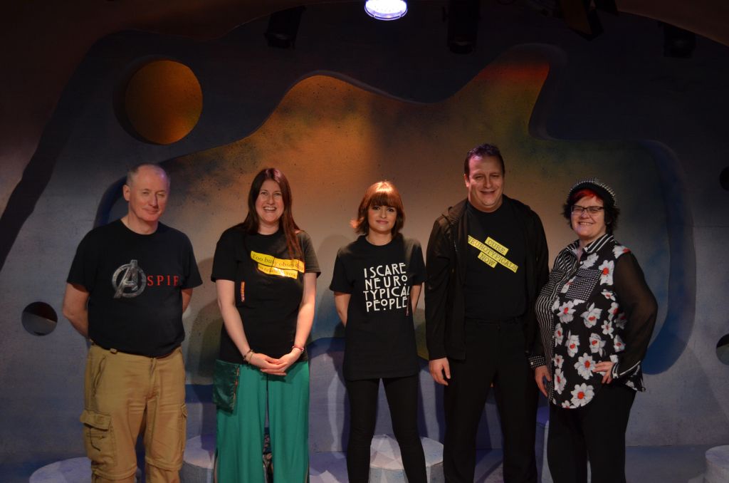 Paul Wady, Sarah Saeed, Hannah Yahya Hussan, Alain English and Janine Booth standing together under a stage light.